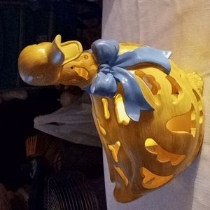 Duck with artificial candle and blue bow10 in. High and 9 long